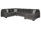 Gray sectional sofa with patterned cushions on a white background