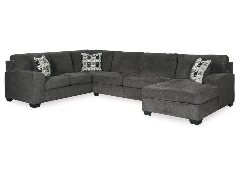 Gray sectional sofa with patterned cushions on a white background