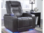 Black leather recliner chair in a room with a side table and decor items.