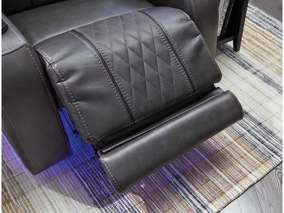 Gray recliner chair with diamond pattern on a striped rug